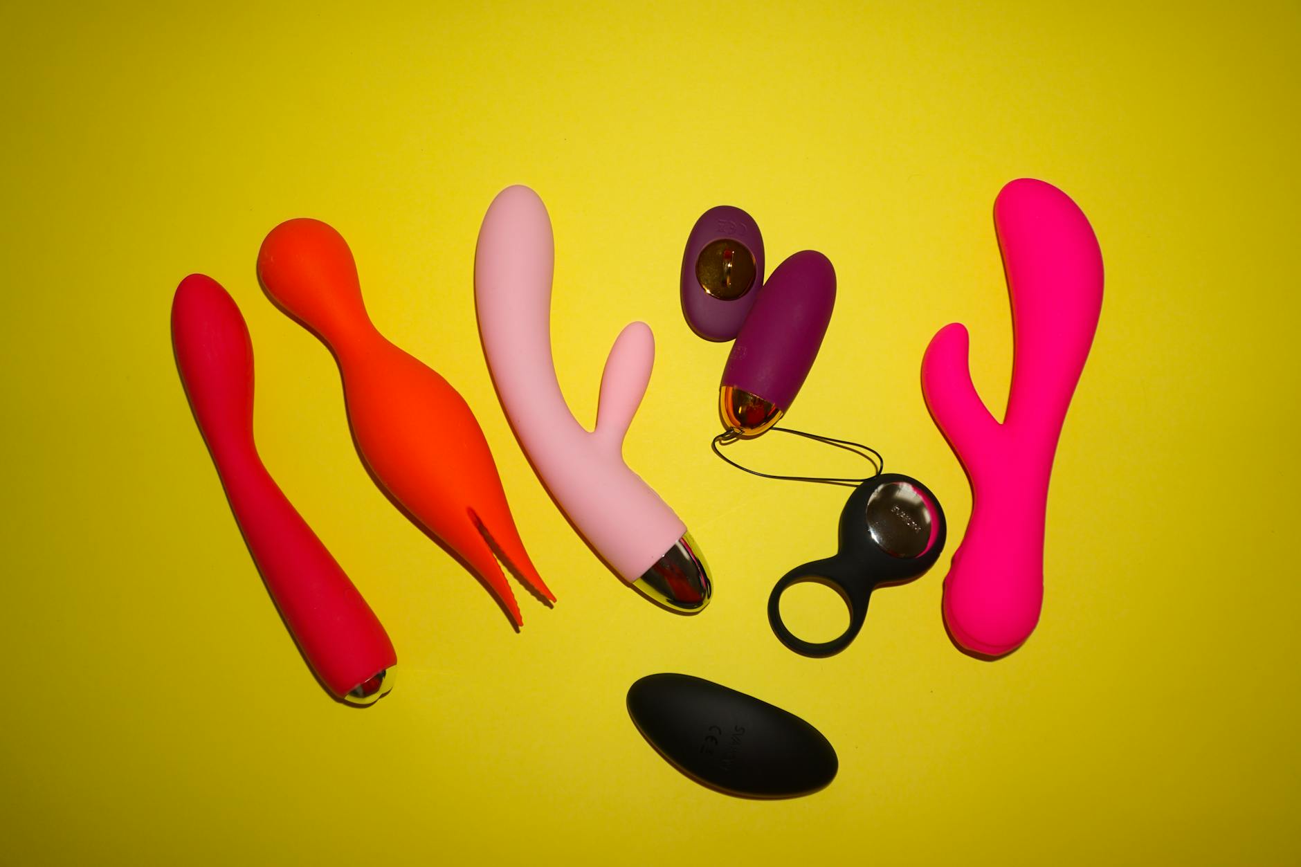 Colorful lemon vibrators and adult toys displayed on a bright yellow background